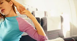 woman stretching on plane