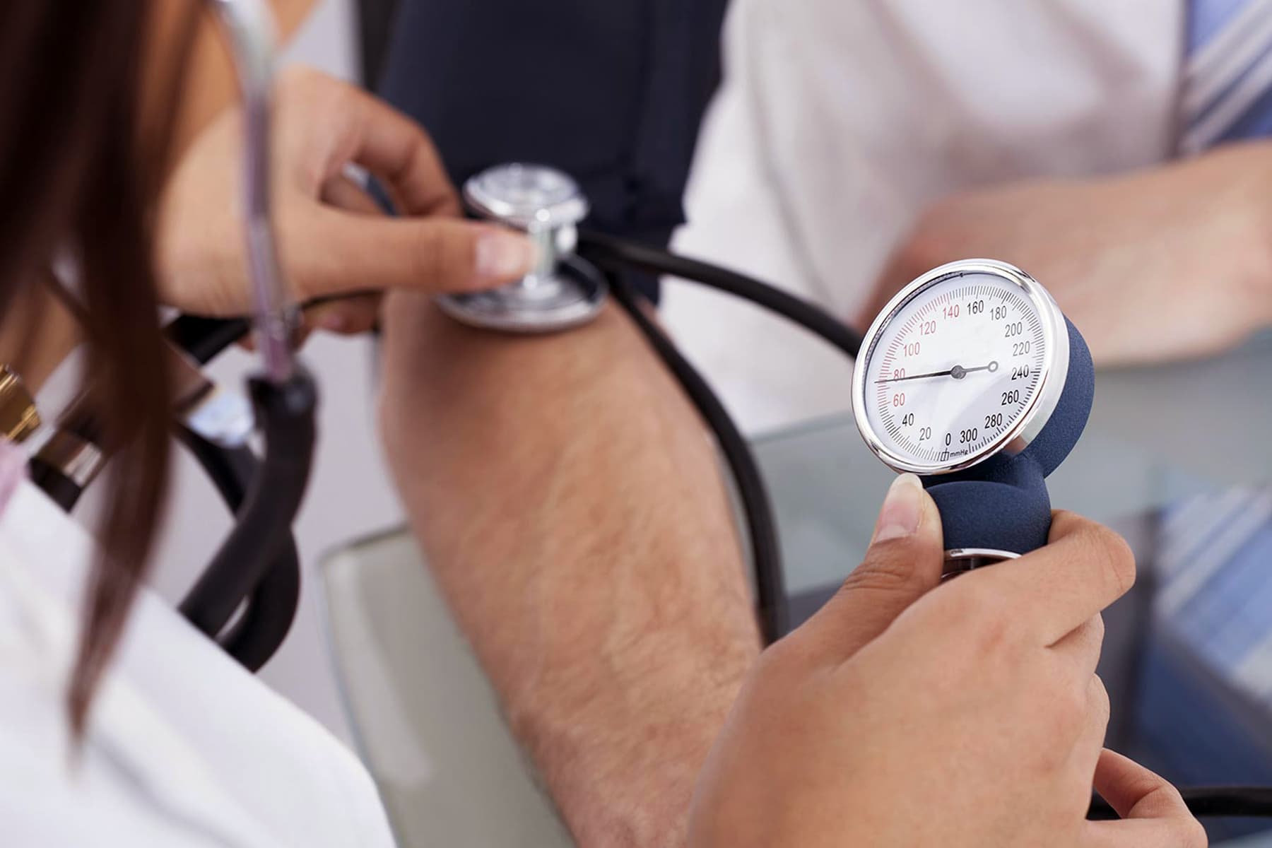 photo of nurse checking man's blood pressure