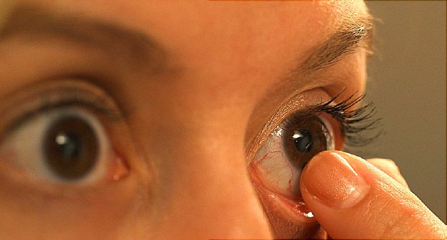 woman putting in contact lenses 