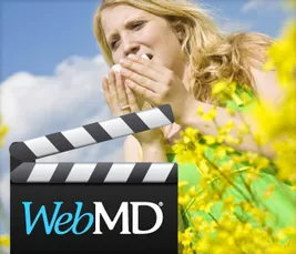 Film slate in front of woman sneezing in field