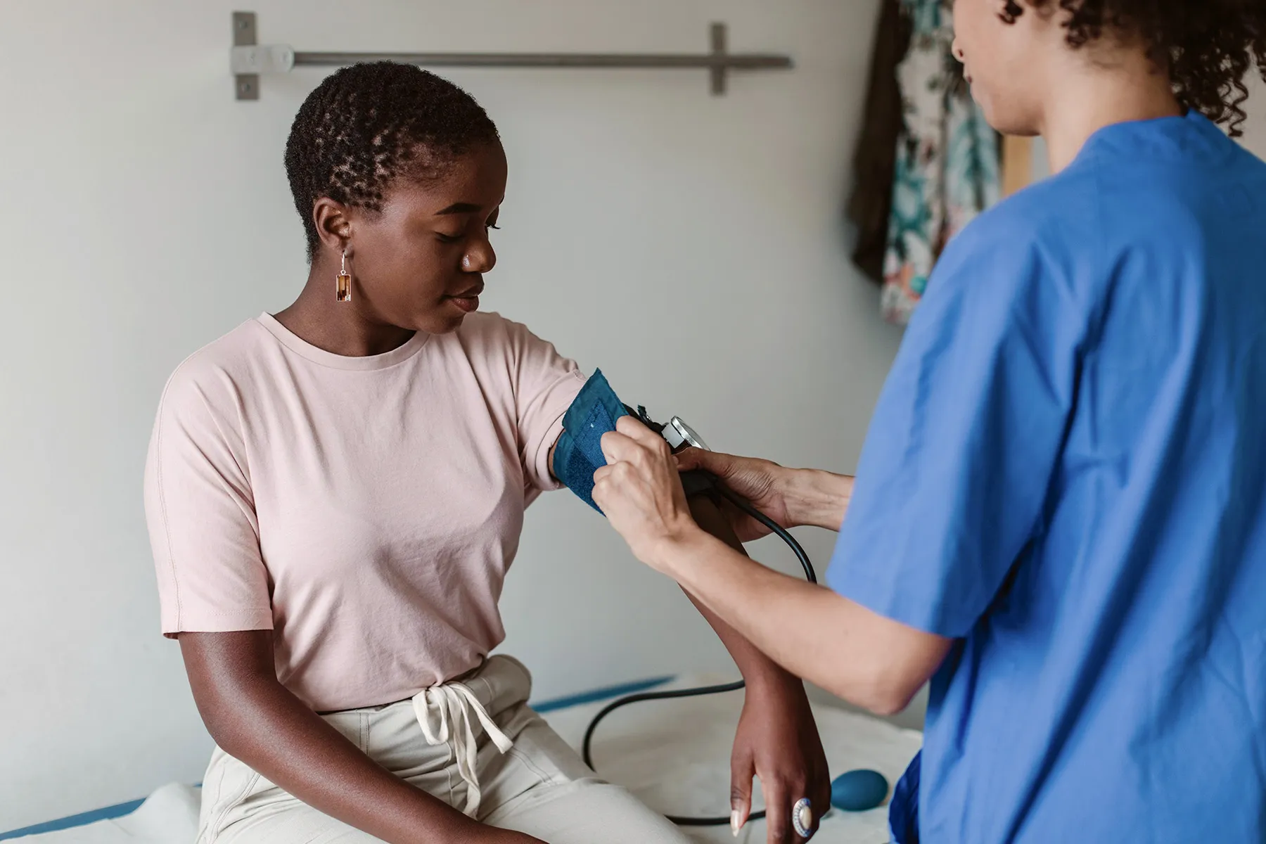 photo of doctor checking patient's blood pressure