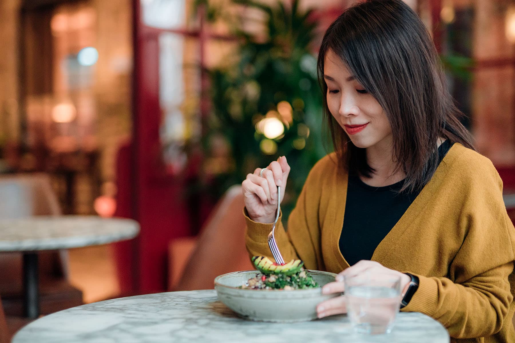 photo of woman eating a salad