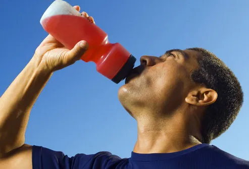 Man drinking sports drink from squeeze bottle