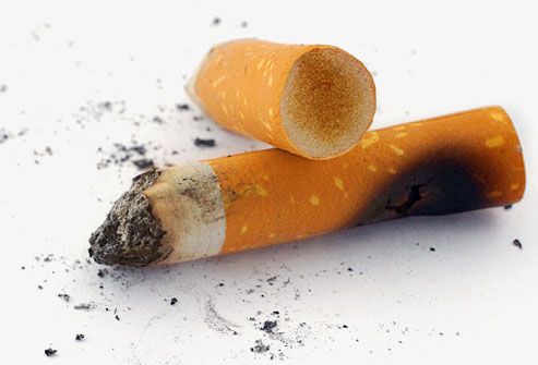 close-up of two cigarette butts and ashes