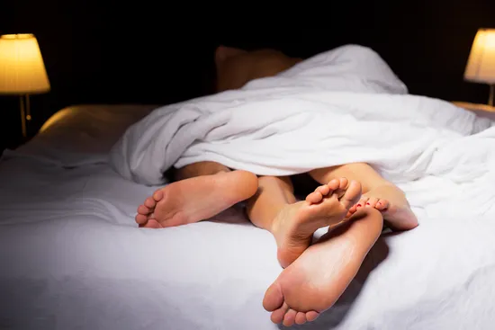 photo of feet in bed