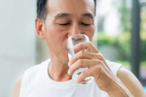 photo of mature man drinking water