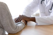 photo of doctor holding patient's hands