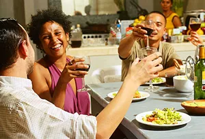 friends enjoying wine with dinner