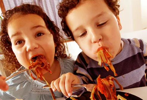 Kids eating pasta