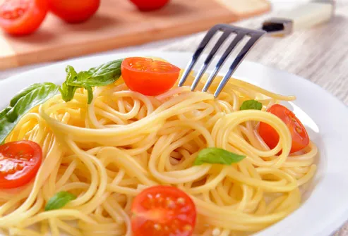 spaghetti with tomatoes on plate