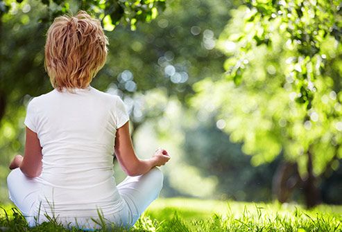 woman meditating outdoors