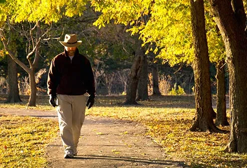 mature man walking alone in park