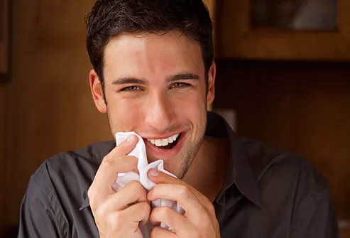 Man wiping his mouth with a napkin
