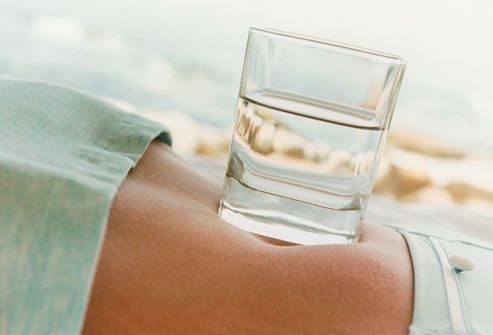 Glass of Water on Woman's Stomach