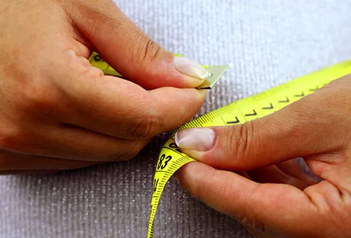 person measuring waistline
