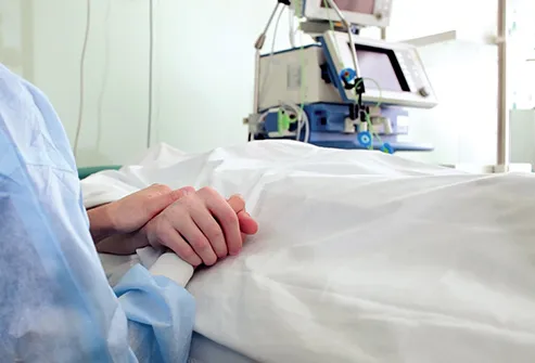 holding hand of patient in hospital