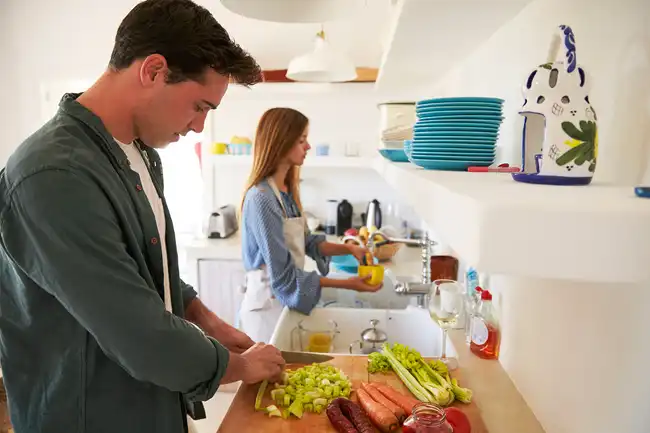couple cooking and cleaning