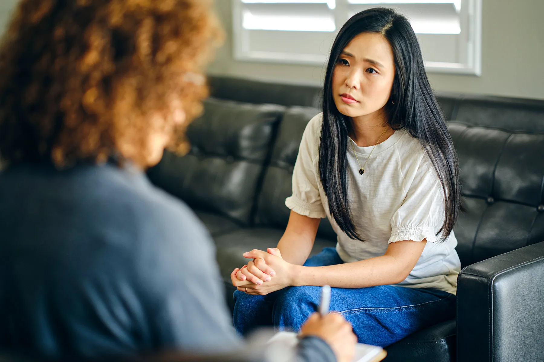 photo of Young woman listening to therapist