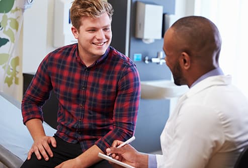 young man talking with doctor