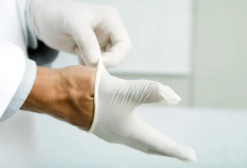 Photo of hands putting on latex gloves