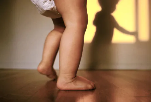 Baby walking casting shadow on wall