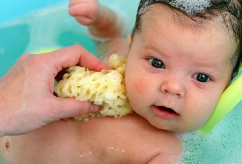 Two-month-old baby taking a bath
