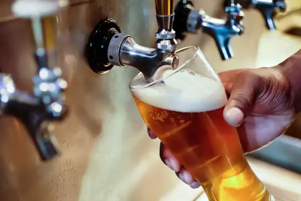 photo of pouring beer on tap