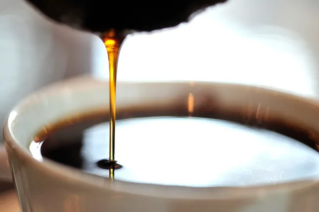 photo of pouring cup of coffee close up