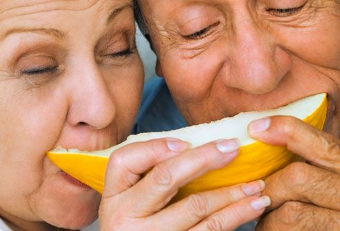 Mature couple sharing fruit