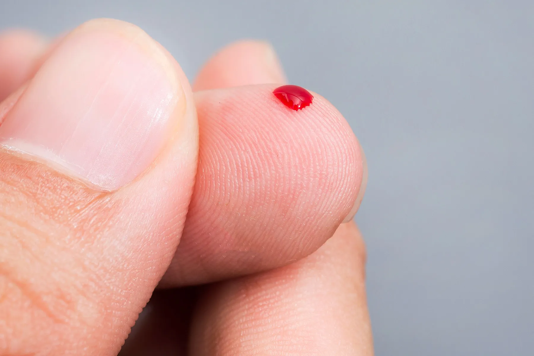 photo of blood drop on finger,
