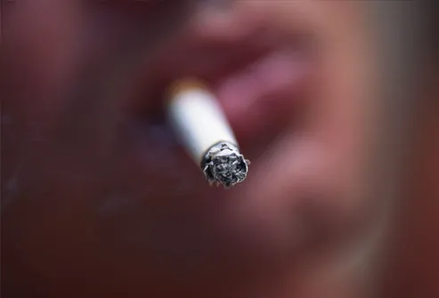 Cigarette in man's mouth