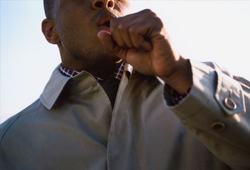 Man coughing outdoors