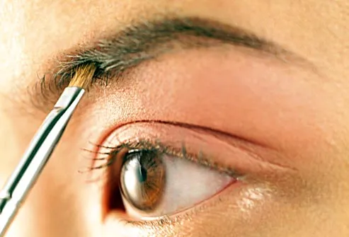woman applying eyebrow makeup