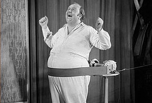 Overweight man using belt massager