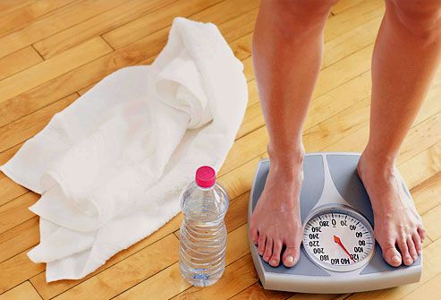 Close up on womans feet on weight scale