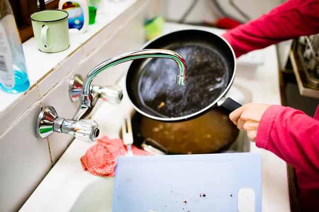 photo of person washing dishes