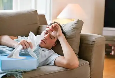 man with cold on couch