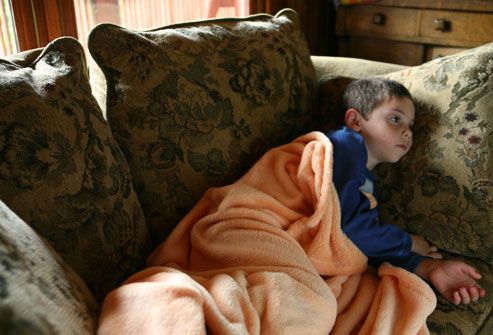 Child with Flu Laying on Couch