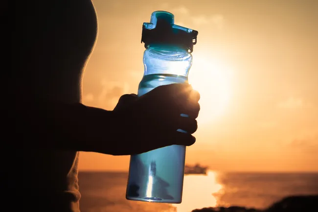 photo of person holding water bottle