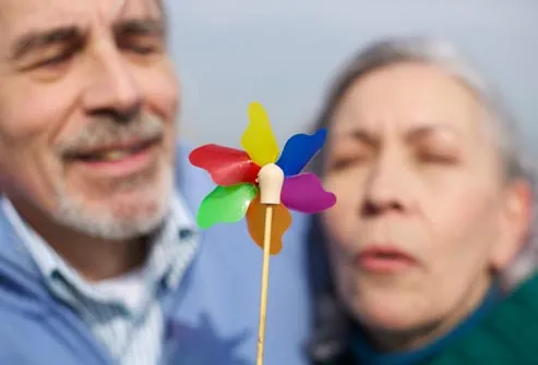 older couple blowing on pinwheel