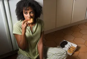 Woman binging on donuts