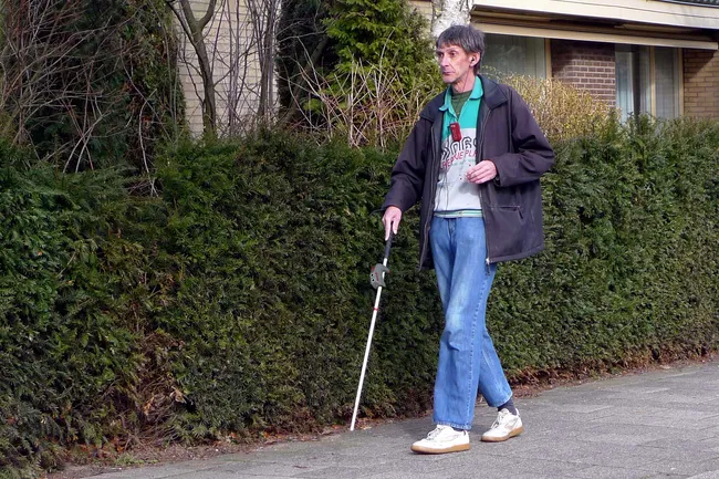 photo of man walking with smart cane