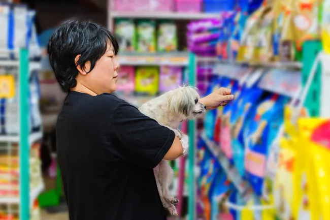 woman choosing dog food