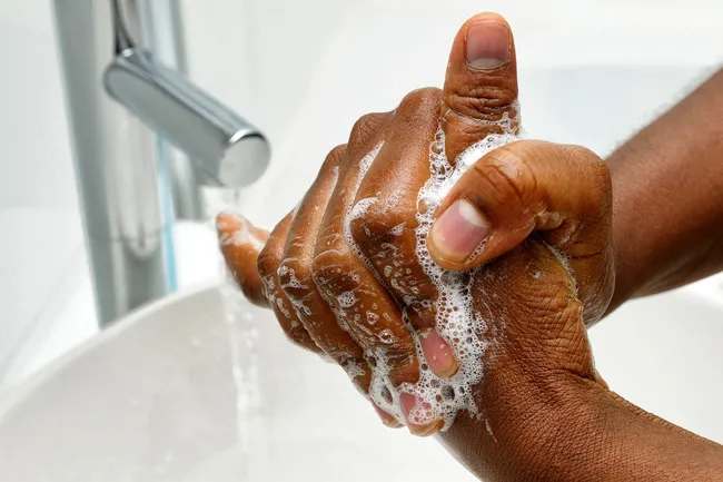 photo of man washing hands