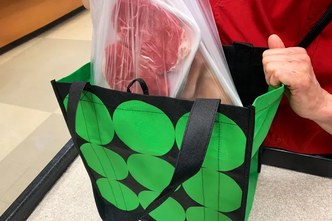 photo of putting meat in grocery bags