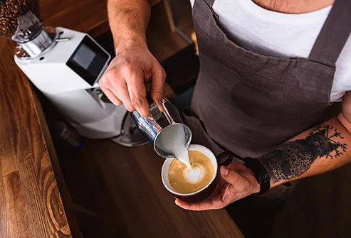 barista making latte