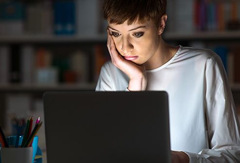 woman working on laptop late at night