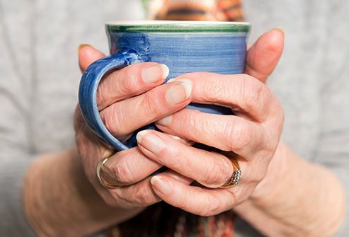 hands holding a cup of tea