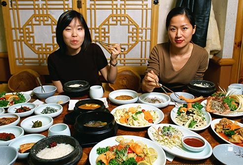 two women eating korean food