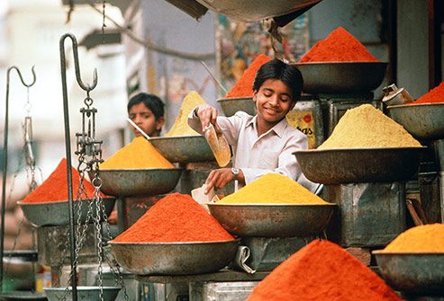 indian boy selling spices in market